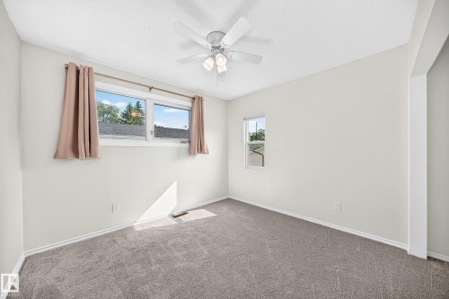 Plush carpeting and ceiling fan with integrated lighting - 12721 117 Street Nw, Edmonton, AB 