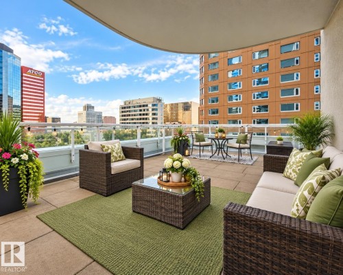 Expansive rooftop patio with concrete pavers and glass panel railing - #605 10152 104 St Nw, Edmonton, AB 