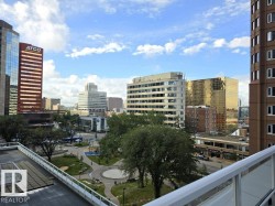 Urban cityscape with varied architectural styles, a public park with mature trees and pathways, and a building with a glass railing balcony - 