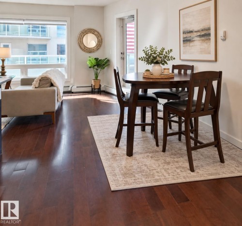 Expansive windows, rich wood-finish flooring, and a glass-paneled door - #605 10152 104 St Nw, Edmonton, AB 