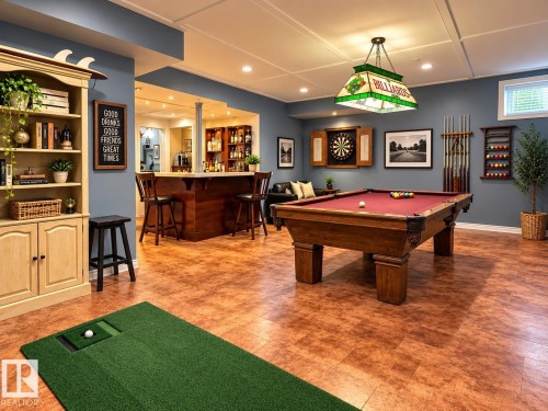 Built-in bar with seating, wood-finish flooring, recessed lighting, and a coffered ceiling - 16893 58A Street Nw, Edmonton, AB 