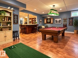 Built-in bar with seating, wood-finish flooring, recessed lighting, and a coffered ceiling - 