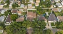 Expansive aerial view of a residential neighborhood featuring multiple single-family homes with brown shingled roofs and varied landscaping - 12121 42 Street Nw, Edmonton, AB  - Outdoor With View 
