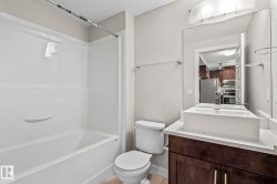 Bathroom featuring a white tub and shower combination with a single-handle faucet - 