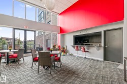 Spacious common area featuring floor-to-ceiling windows, a full-service bar area, and contemporary patterned carpeting - 