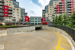 Curved concrete ramp leading to an underground parking garage entrance - 
