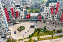 Contemporary residential buildings featuring red and white paneling with glass balconies - 