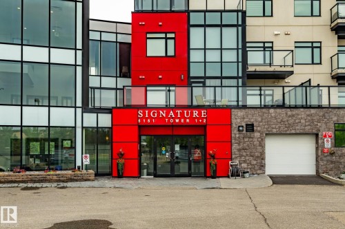 Modern building facade featuring vibrant red paneling and expansive glass windows - 5151 Windermere  Bv Sw, Edmonton, AB - Outdoor