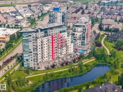 Modern high-rise residential building featuring multiple balconies, a rooftop amenity space, and an outdoor swimming pool - 