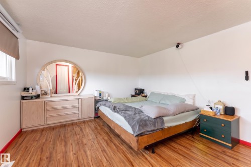 Wood-finish flooring with white walls and a single window - 17928 93 Ave Nw, Edmonton, AB 
