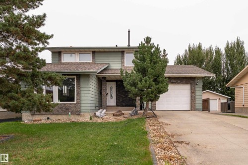 Two-story residence featuring green siding and stone accents - 17928 93 Ave Nw, Edmonton, AB 