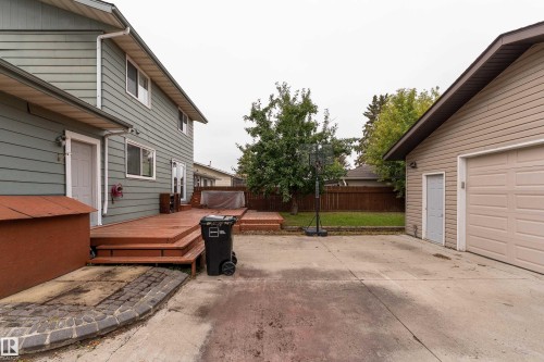 Expansive concrete driveway, detached two-car garage, and multi-level wood deck - 17928 93 Ave Nw, Edmonton, AB 