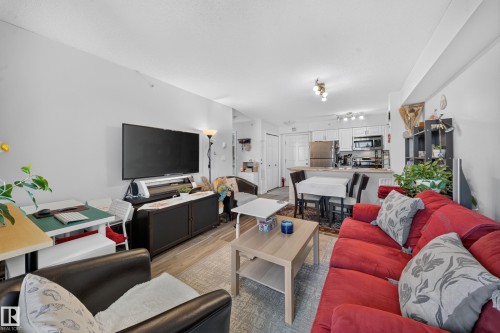 Open-concept living space with wood-finish flooring - #419 920 156 St Nw, Edmonton, AB 