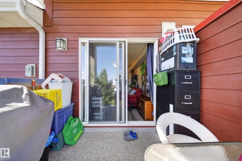 Sliding glass door access to an outdoor area with textured flooring - #419 920 156 St Nw, Edmonton, AB 
