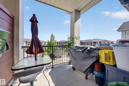 Outdoor balcony with textured flooring and a black metal railing - #419 920 156 St Nw, Edmonton, AB 