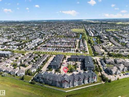 Multi-story residential complex with dark-toned roofing and light-colored siding - #419 920 156 St Nw, Edmonton, AB 