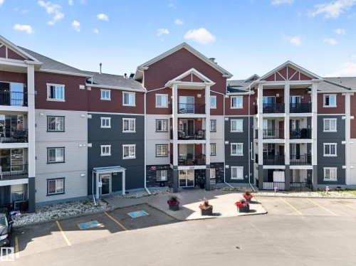 Multi-story building featuring balconies, a multi-tone exterior, covered entryways, and paved parking - #419 920 156 St Nw, Edmonton, AB 