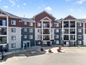 Multi-story building featuring balconies, a multi-tone exterior, covered entryways, and paved parking - #419 920 156 St Nw, Edmonton, AB 