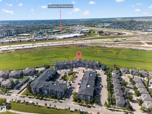 Expansive community featuring multi-story residential buildings, paved parking areas, and surrounding green spaces - #419 920 156 St Nw, Edmonton, AB 