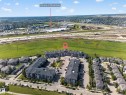 Expansive community featuring multi-story residential buildings, paved parking areas, and surrounding green spaces - #419 920 156 St Nw, Edmonton, AB 