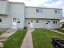 Light grey horizontal vinyl siding exterior with white window trim - 140 Dickinsfield Court Nw, Edmonton, AB 