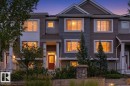 Multi-level exterior with horizontal siding, prominent window trim, and a gabled roofline - #12 1391 Starling Dr Nw, Edmonton, AB 