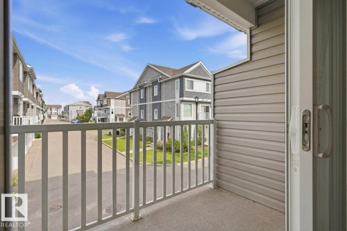 Balcony with textured flooring, white railings, and siding exterior - #12 1391 Starling Dr Nw, Edmonton, AB 