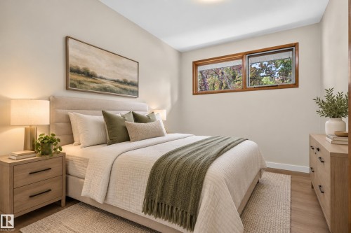 Neutral wall color, wood-finish flooring, and a large window with wood trim - 2 Grandora Crescent, St. Albert, AB 