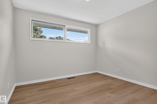 Neutral wall finishes, wood-finish flooring, and white trim - 2 Grandora Crescent, St. Albert, AB 