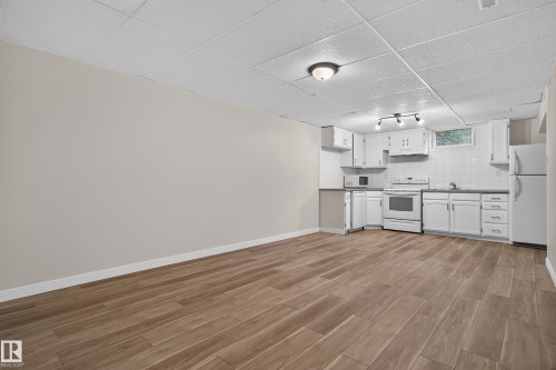 Full kitchen with white cabinetry, tile backsplash, and appliances - 2 Grandora Crescent, St. Albert, AB 