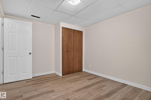 Wood-finish flooring, neutral wall paint, and white trim - 2 Grandora Crescent, St. Albert, AB 