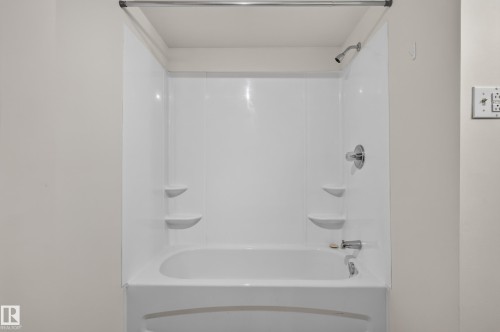 Bathtub shower combination with white surround, chrome showerhead, and matching chrome fixtures - 2 Grandora Crescent, St. Albert, AB 