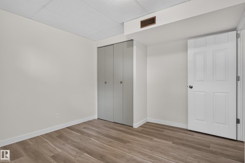 Wood-finish flooring, white walls, and a multi-panel door - 2 Grandora Crescent, St. Albert, AB 