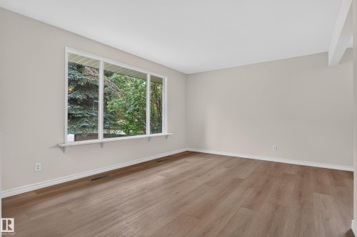 Neutral wall color, wood-finish flooring, white window trim, white baseboards, and a window ledge - 2 Grandora Crescent, St. Albert, AB 
