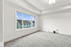 Tray ceiling with recessed lighting and a central ceiling fixture - 