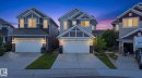 Two-story residence featuring a two-car garage, stone accents, and varied siding textures - 4530 Saly Place Sw, Edmonton, AB 