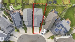 Curb-side property on a cul-de-sac featuring an attached garage and a multi-level roof - 