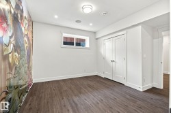Wood-finish flooring, recessed lighting, double closet doors, and an accent wall - 