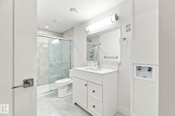 White shaker vanity with a single basin sink and stone countertop - 