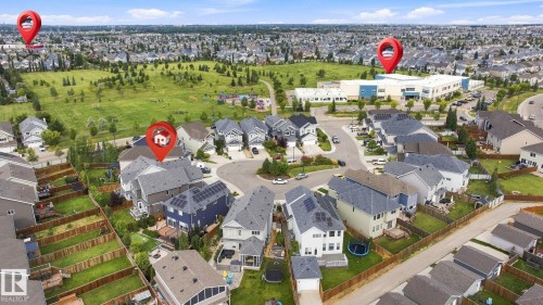 Expansive residential neighborhood with varied architectural styles, green spaces, and a prominent community building - 4530 Saly Place Sw, Edmonton, AB 