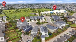 Expansive residential neighborhood with varied architectural styles, green spaces, and a prominent community building - 