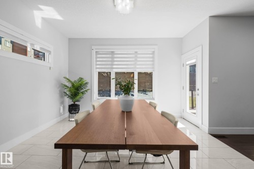 Bright interior with tile flooring, large window with blinds, and white trim throughout - 2019 Ware Rd Nw, Edmonton, AB 
