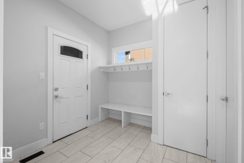 Tile flooring, built-in bench, and built-in coat hooks - 2019 Ware Rd Nw, Edmonton, AB 
