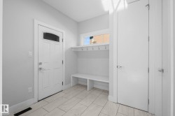 Tile flooring, built-in bench, and built-in coat hooks - 