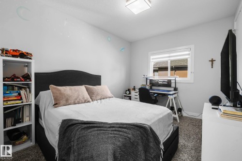 Neutral wall paint, carpeted flooring, and a large window with blinds - 2019 Ware Rd Nw, Edmonton, AB 