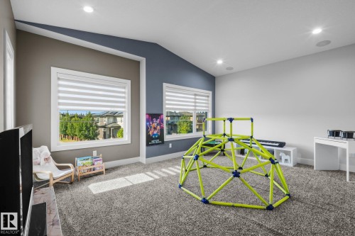 Recessed lighting, wall-to-wall carpeting, multiple windows with blinds, and an architectural ceiling detail - 2019 Ware Rd Nw, Edmonton, AB 