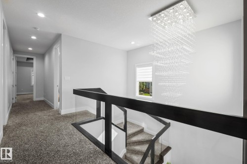 Modern chandelier with cascading crystal elements - 2019 Ware Rd Nw, Edmonton, AB 