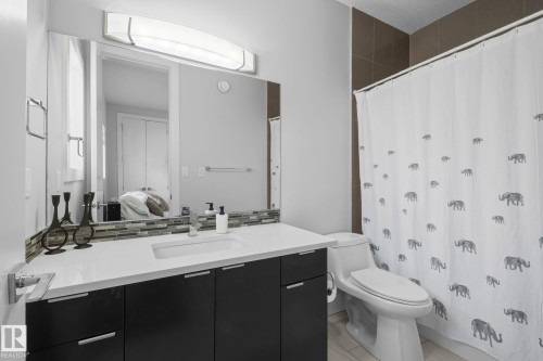 Vanity with a single basin, integrated countertop, and dark wood-finish cabinetry - 2019 Ware Rd Nw, Edmonton, AB 