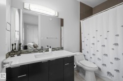 Vanity with a single basin, integrated countertop, and dark wood-finish cabinetry - 