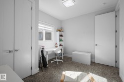 Carpeted flooring, white walls, and a window with blinds - 